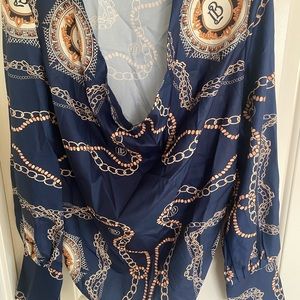 Brand new, navy blue women’s blouse with chain drawings throughout.